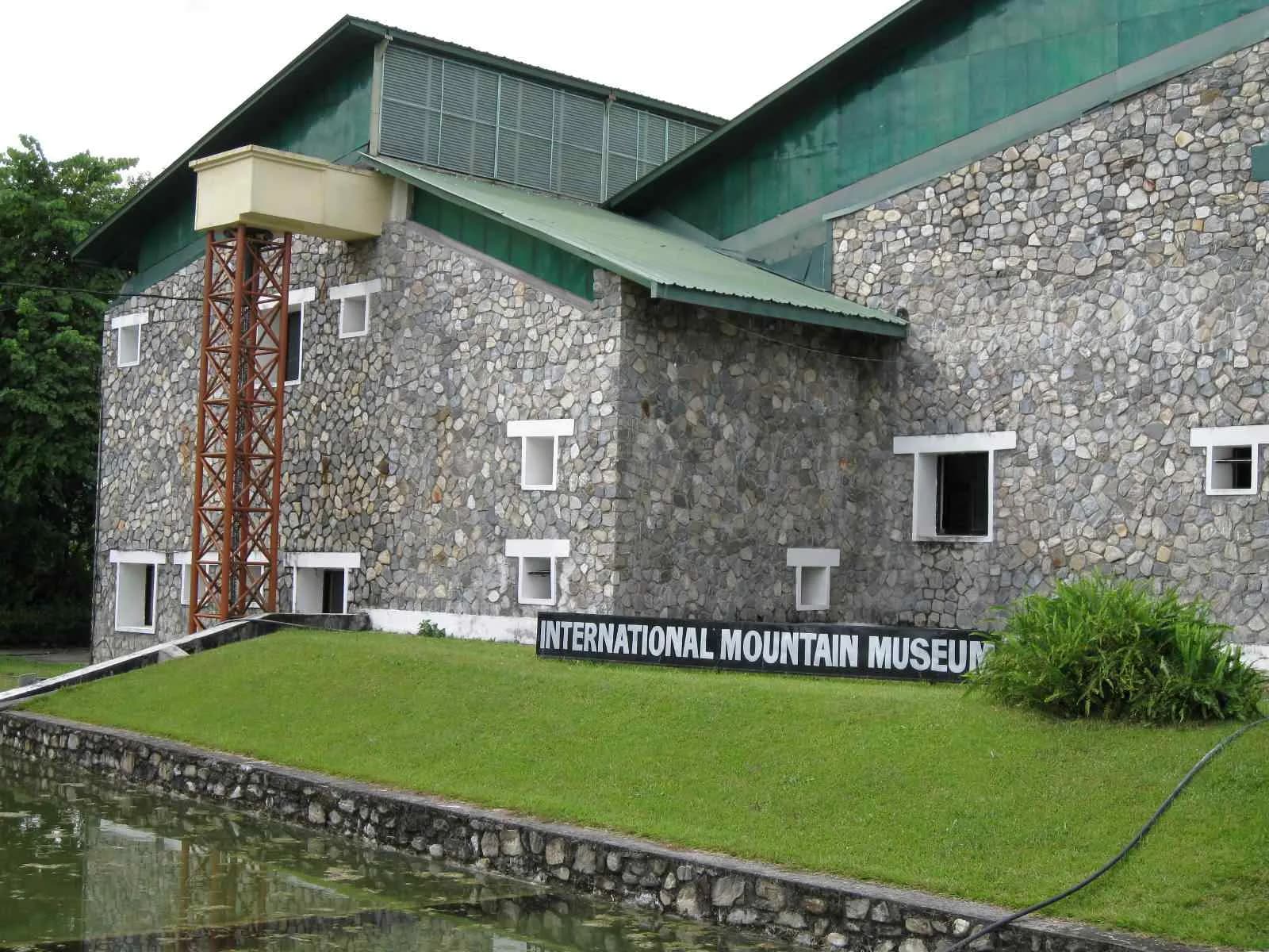 Stone exterior of the International Mountain Museum in Pokhara under a clear sky