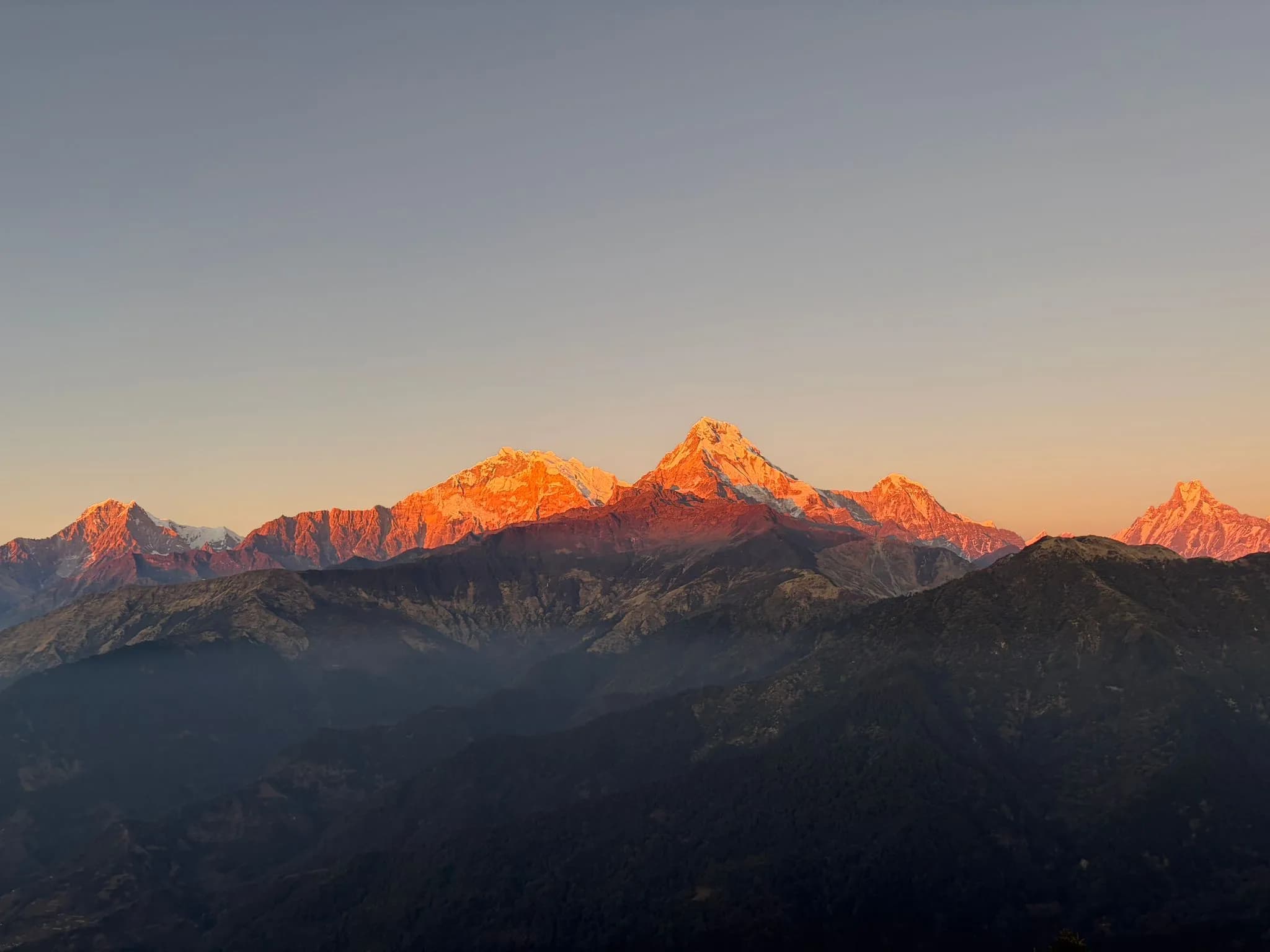 Wide-angle landscape of the Annapurna Sanctuary valley surrounded by towering 7000m peaks